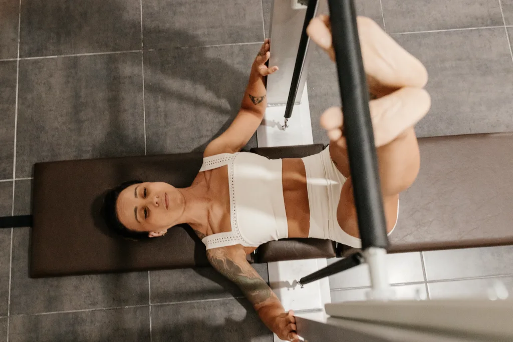 Ejercicio terapéutico en máquina de pilates para fuerza y control corporal en Barcelona
